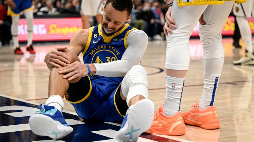 DENVER, CO – FEBRUARY 2: Stephen Curry (30) of the Golden State Warriors holds his knee after being fouled by Michael Porter Jr. (1) of the Denver Nuggets during the second quarter at Ball Arena in Denver on Thursday, February 2, 2023. (Photo by AAron Ontiveroz/MediaNews Group/The Denver Post via Getty Images)