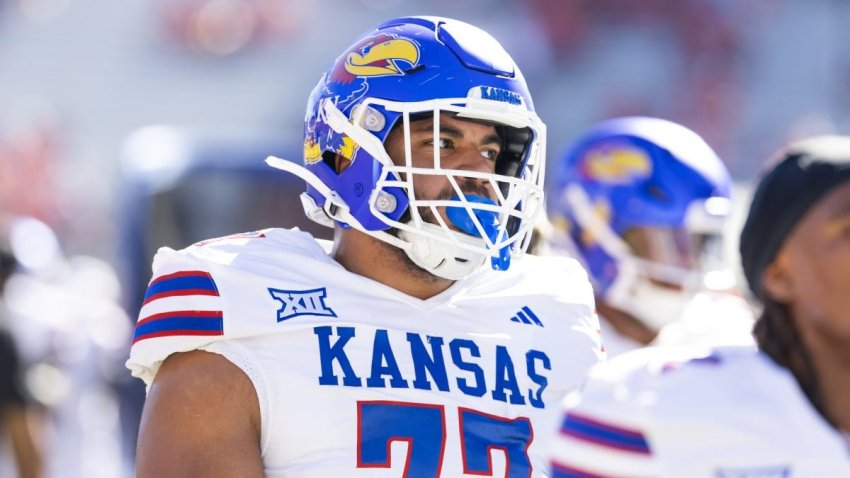 Nov 8, 2025; Tucson, Arizona, USA; Kansas Jayhawks offensive lineman Enrique Cruz Jr. (77) against the Arizona Wildcats at Arizona Stadium. Mandatory Credit: Mark J. Rebilas-Imagn Images