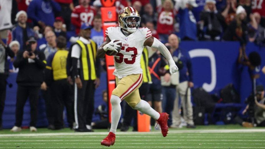 Dec 22, 2025; Indianapolis, Indiana, USA; San Francisco 49ers linebacker Dee Winters (53) carries the ball after an interception for a touchdown against the Indianapolis Colts in the fourth quarter of the game at Lucas Oil Stadium. Mandatory Credit: Trevor Ruszkowski-Imagn Images