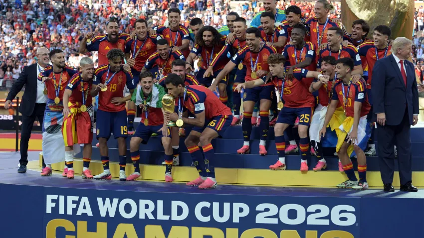 Spain's midfielder #16 Rodri kisses the trophy as he celebrates with his teammates.