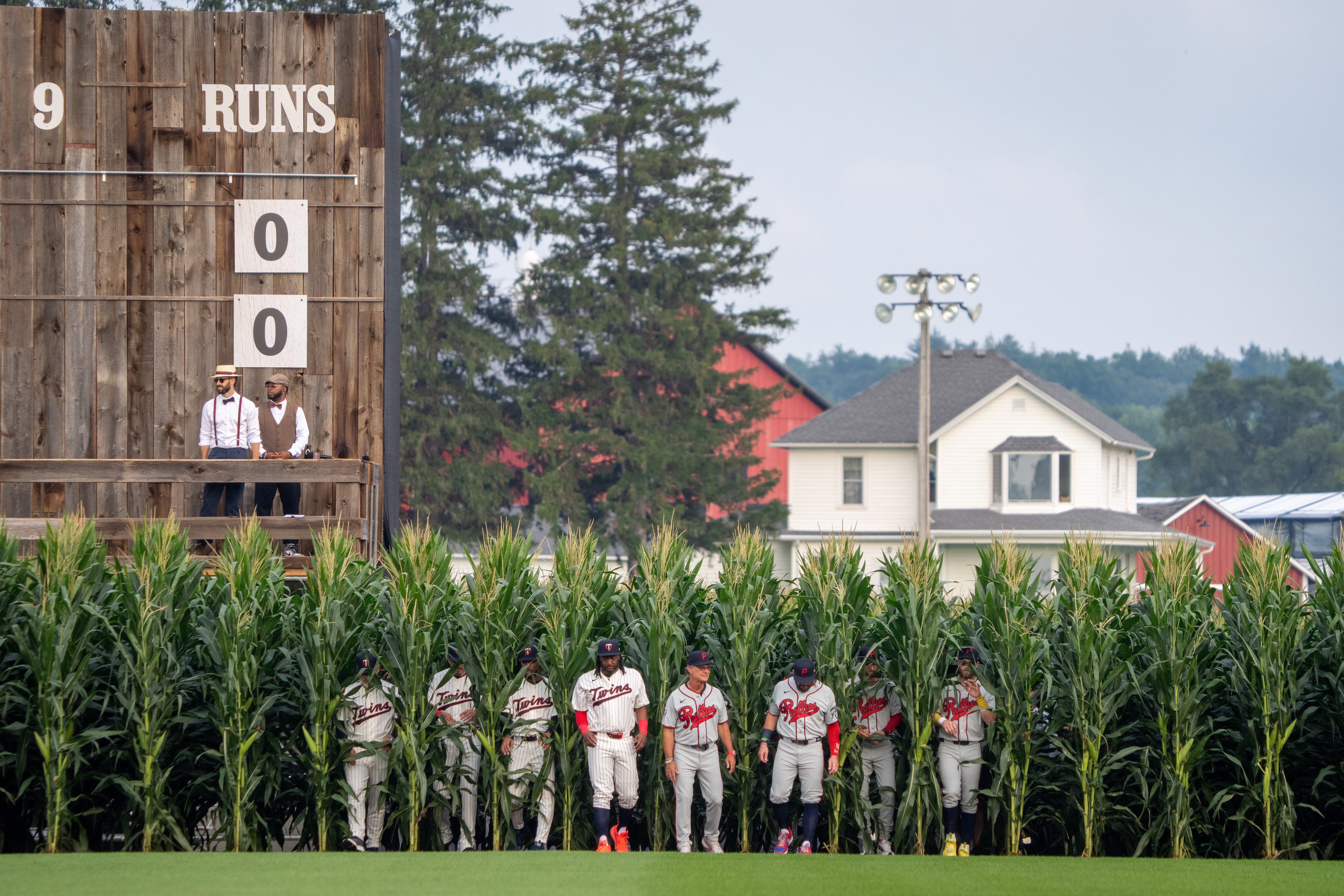 Philadelphia Phillies and Minnesota Twins players emerging through corn at the 2026 MLB Field of Dreams Game