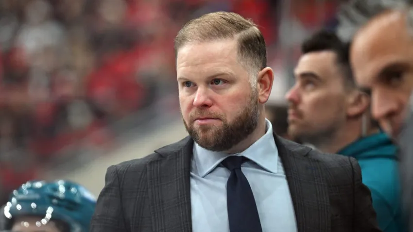 RALEIGH, NC – DECEMBER 07: Head Coach Ryan Warsofsky of the San Jose Sharks watches the play develop from the bench during the NHL game between the San Jose Sharks and the Carolina Hurricanes on December 7, 2025 at Lenovo Center in Raleigh, North Carolina. (Photo by Katherine Gawlik/Icon Sportswire via Getty Images)