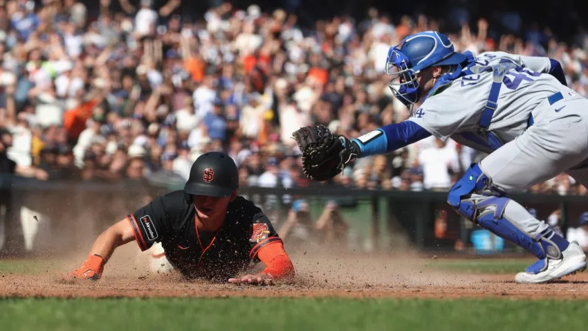 SAN FRANCISCO, CALIFORNIA – SEPTEMBER 26: Turner Hill #52 of the San Francisco Giants slides safely into home plate ahead of a tag by catcher Hunter Feduccia #46 of the Los Angeles Dodgers to score on a sacrifice fly ball by Bo Davidson #94 of the San Francisco Giants in the bottom of the eighth inning at Oracle Park on September 26, 2026 in San Francisco, California. (Photo by Lachlan Cunningham/Getty Images)