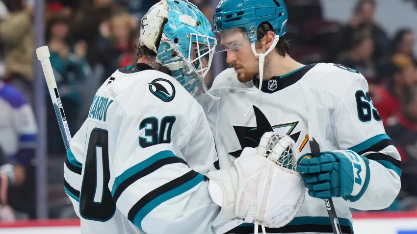 OTTAWA, CANADA – OCTOBER 22:  Yaroslav Askarov #30 of the San Jose Sharks celebrates a 6-2 win against the Ottawa Senators with teammate Zack Ostapchuk #63 on October 22, 2026 at Canadian Tire Centre in Ottawa, Ontario, Canada.  (Photo by André Ringuette/NHLI via Getty Images)